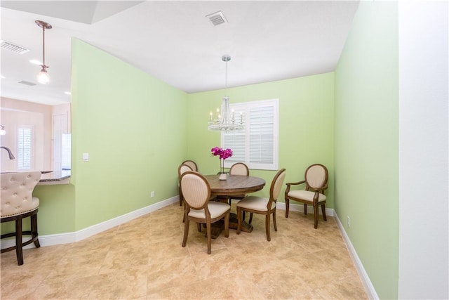 1122 4th Ln SW, Vero Beach, FL 32962 - dining area featuring a chandelier and baseboards
