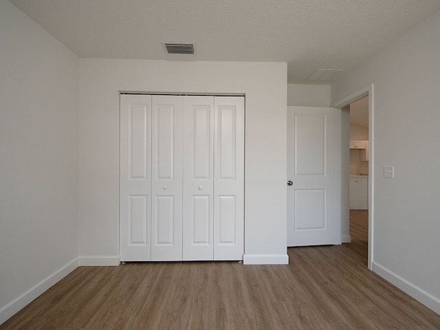 6156 6th Pl, Vero Beach, FL 32968 - unfurnished bedroom with wood finished floors, baseboards, and a closet