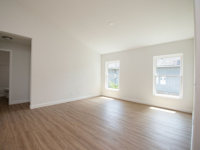 6156 6th Pl, Vero Beach, FL 32968 - unfurnished room featuring light wood-style floors, baseboards, and lofted ceiling