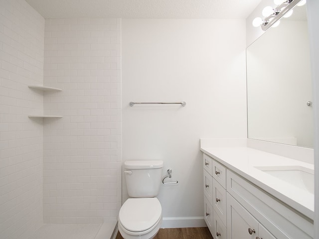 6156 6th Pl, Vero Beach, FL 32968 - full bath with vanity, toilet, tiled shower, wood finished floors, and baseboards