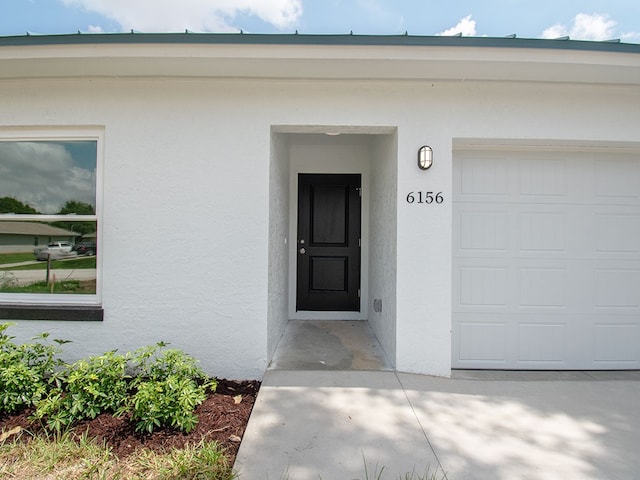 6156 6th Pl, Vero Beach, FL 32968 - entrance to property with stucco siding and a garage