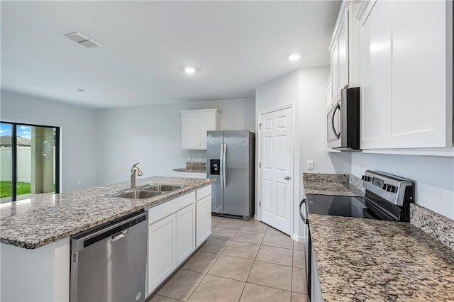 kitchen featuring appliances with stainless steel finishes, a kitchen island with sink, sink, and white cabinets