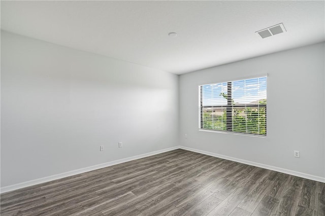 unfurnished room with dark hardwood / wood-style floors