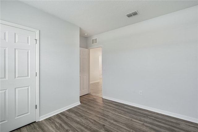 unfurnished bedroom with dark hardwood / wood-style flooring