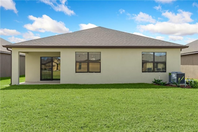 back of property with a patio area, central air condition unit, and a lawn