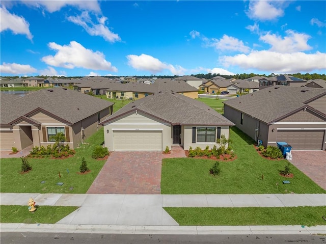 ranch-style house with a garage and a front lawn