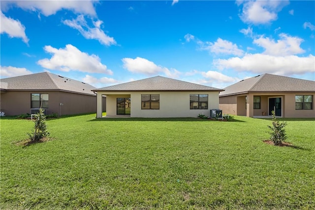 rear view of property with a yard