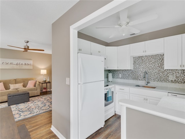 kitchen with decorative backsplash, white cabinetry, dark hardwood / wood-style flooring, and white appliances