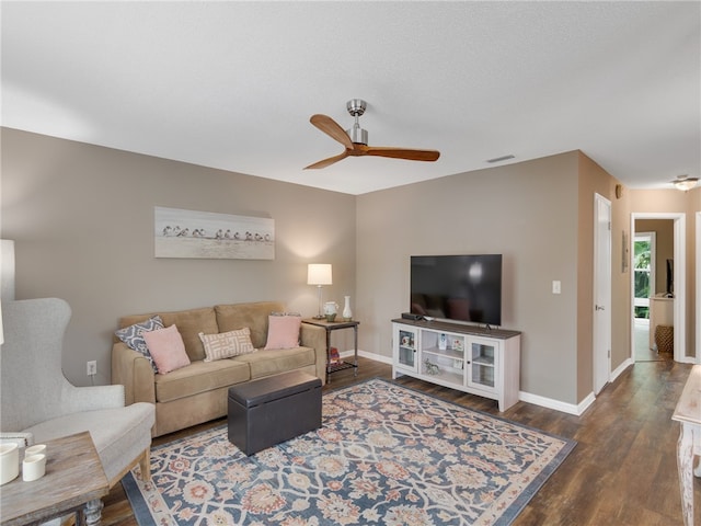 living room with dark hardwood / wood-style floors and ceiling fan