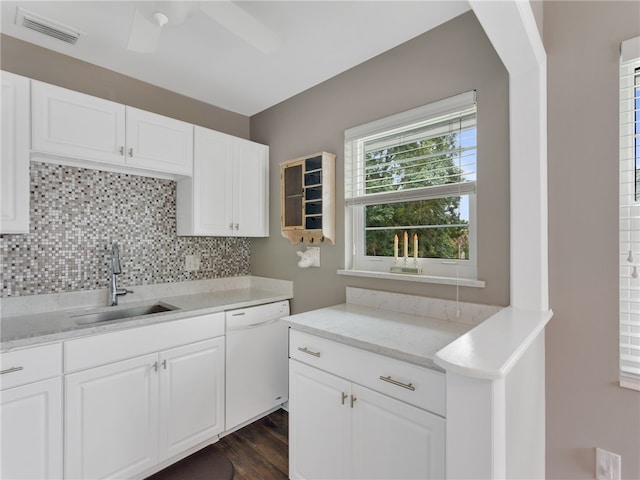 kitchen featuring white cabinetry, dishwasher, sink, dark hardwood / wood-style flooring, and decorative backsplash