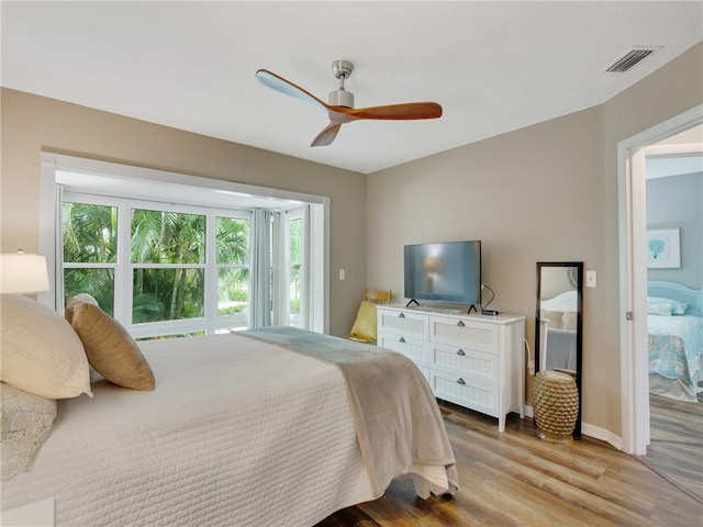 bedroom with ceiling fan and light hardwood / wood-style flooring