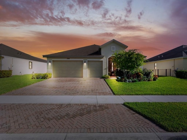 10060 Verona Mnr, Vero Beach, FL 32966 - view of front of home featuring stucco siding, decorative driveway, a front yard, and a garage