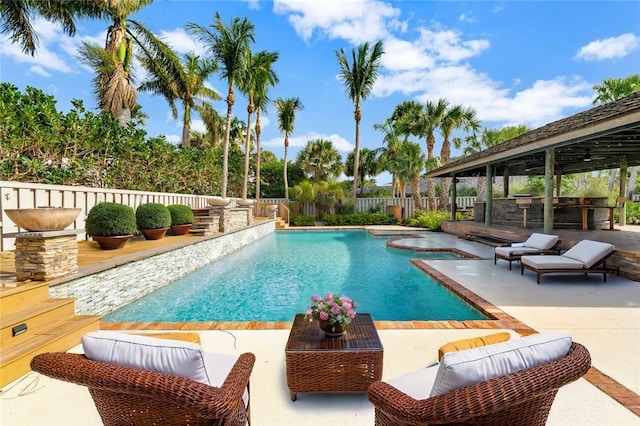 view of pool with a patio and an outdoor bar