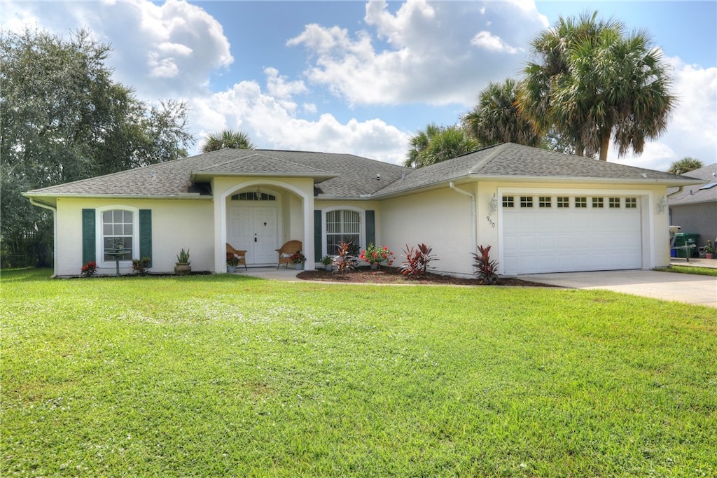 ranch-style house with a garage and a front lawn