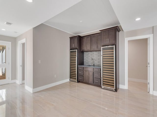 8405 Red Bay Ct Unit 8405, Vero Beach, FL 32963 - unfurnished living room featuring wet bar, baseboards, a sink, and wine cooler