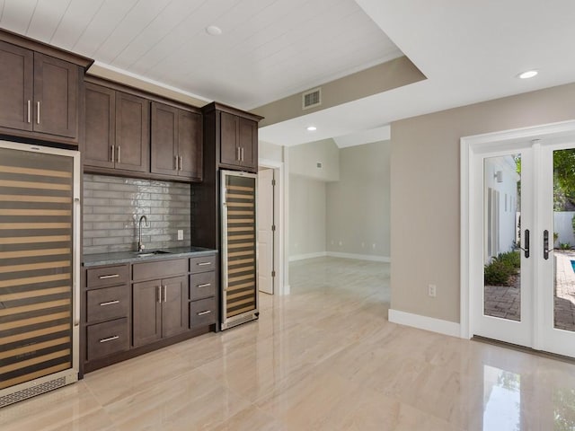8405 Red Bay Ct Unit 8405, Vero Beach, FL 32963 - interior space featuring visible vents, baseboards, a sink, dark brown cabinets, and beverage cooler