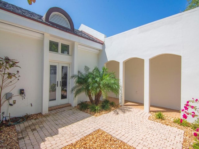8405 Red Bay Ct Unit 8405, Vero Beach, FL 32963 - property entrance featuring french doors, a patio area, and stucco siding