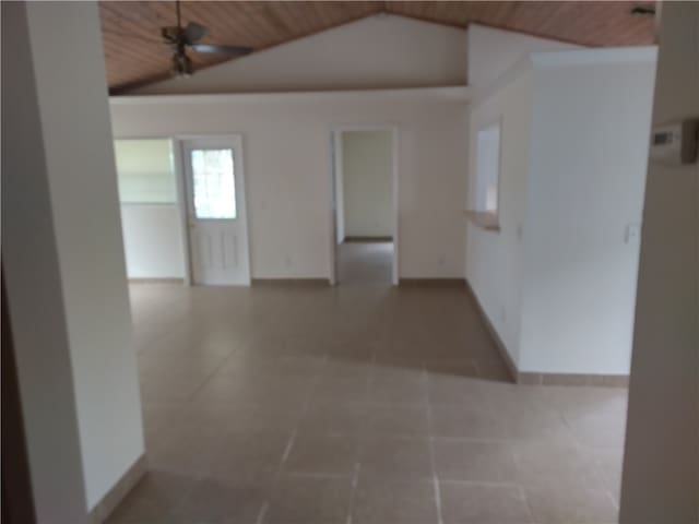 interior space with lofted ceiling, ceiling fan, tile patterned floors, and wood ceiling