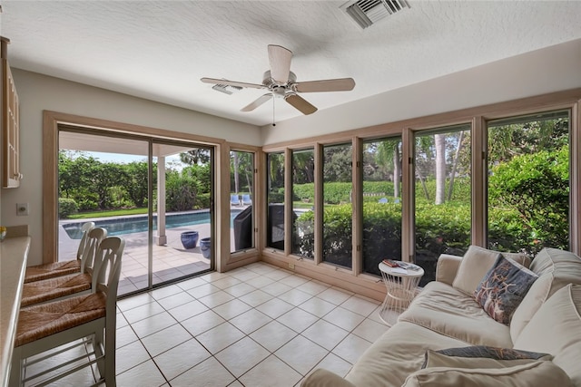 sunroom featuring ceiling fan