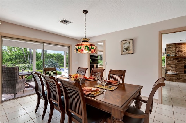 dining room with light tile patterned floors and a textured ceiling