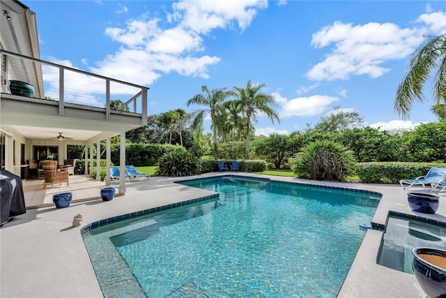 view of swimming pool featuring ceiling fan, a patio, and grilling area