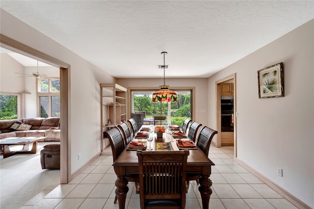 dining space with a textured ceiling, ceiling fan, a healthy amount of sunlight, and light tile patterned flooring