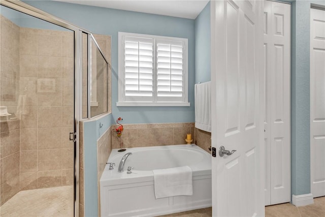 bathroom with shower with separate bathtub and tile patterned floors