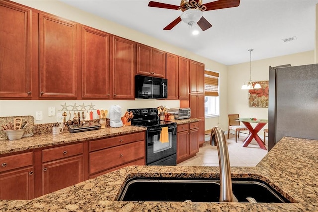 kitchen featuring sink, hanging light fixtures, light stone countertops, ceiling fan with notable chandelier, and black appliances