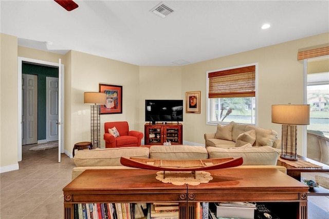 living room featuring a wealth of natural light and light tile patterned floors