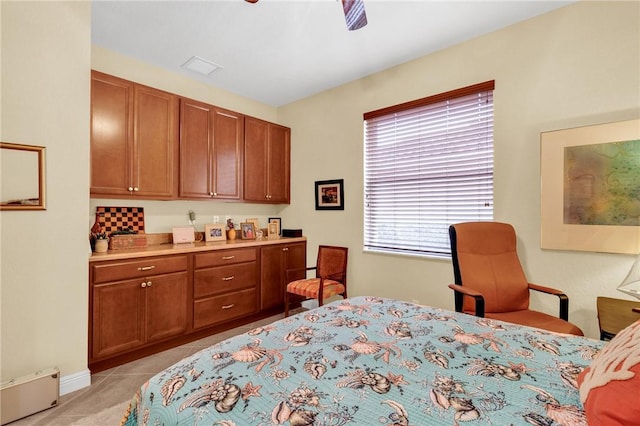 tiled bedroom with a baseboard radiator and ceiling fan