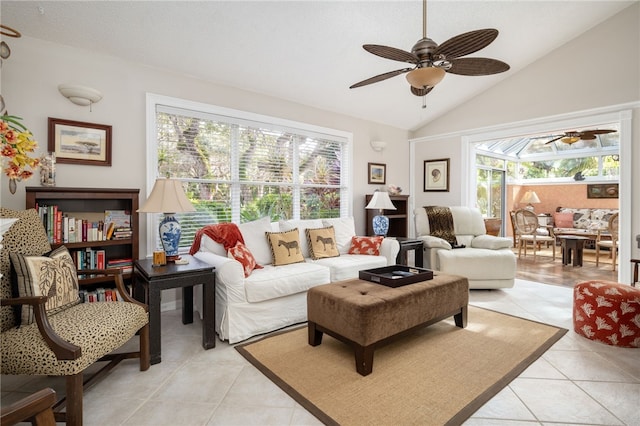 living room featuring ceiling fan, lofted ceiling, and light tile patterned floors