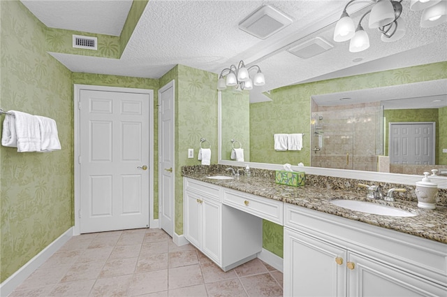 full bathroom featuring a closet, a sink, visible vents, and wallpapered walls