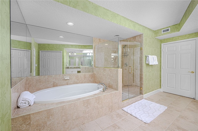 bathroom featuring a garden tub, a closet, visible vents, a stall shower, and a textured ceiling