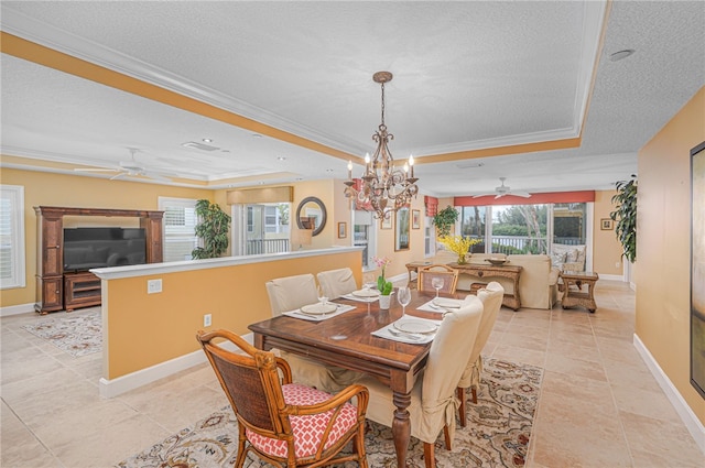 dining area featuring a tray ceiling, a healthy amount of sunlight, crown molding, and a textured ceiling