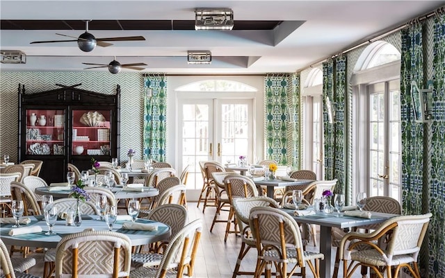 dining area featuring a ceiling fan, wood finished floors, and french doors