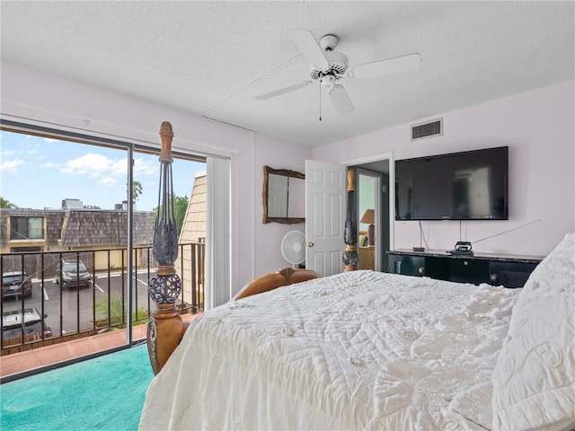 carpeted bedroom with access to exterior, a textured ceiling, and ceiling fan