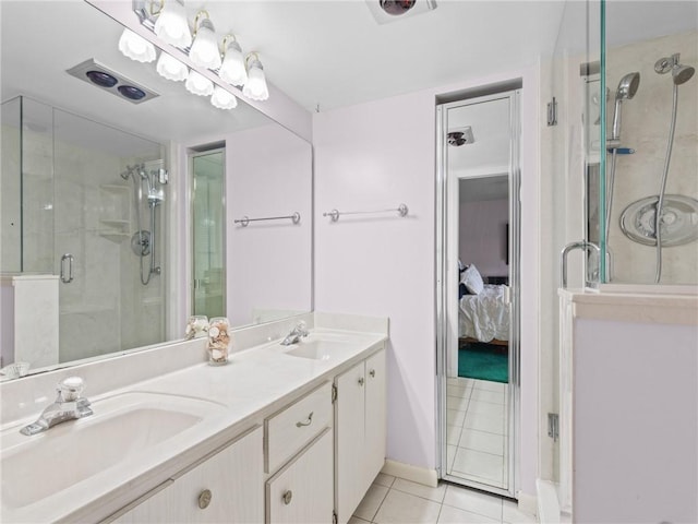 bathroom with vanity, a shower with door, and tile patterned floors