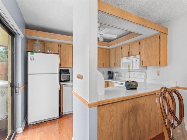 kitchen featuring white appliances, ceiling fan, kitchen peninsula, a textured ceiling, and light wood-type flooring