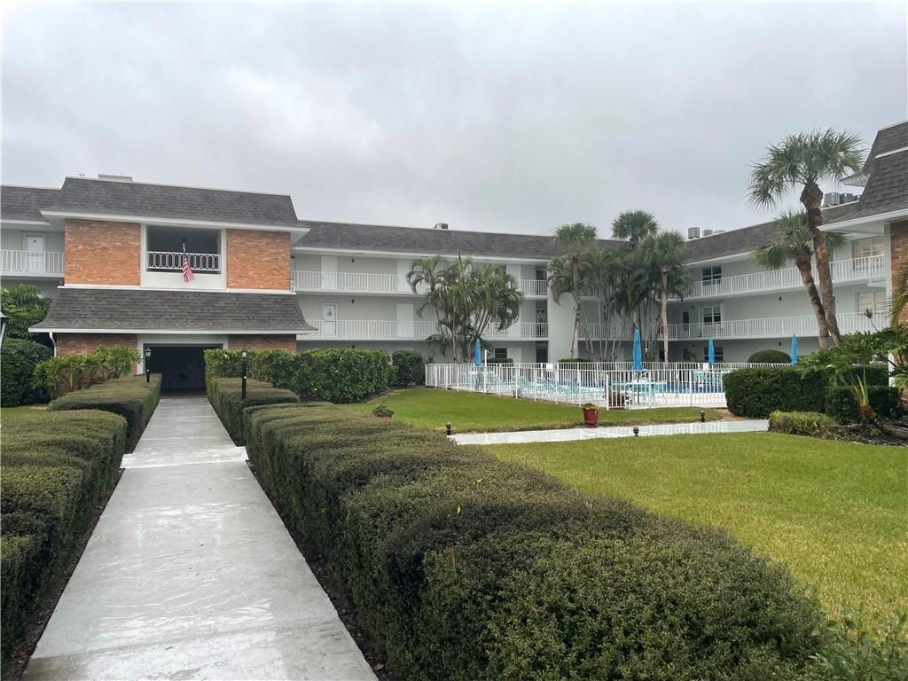 view of community featuring a swimming pool and a yard