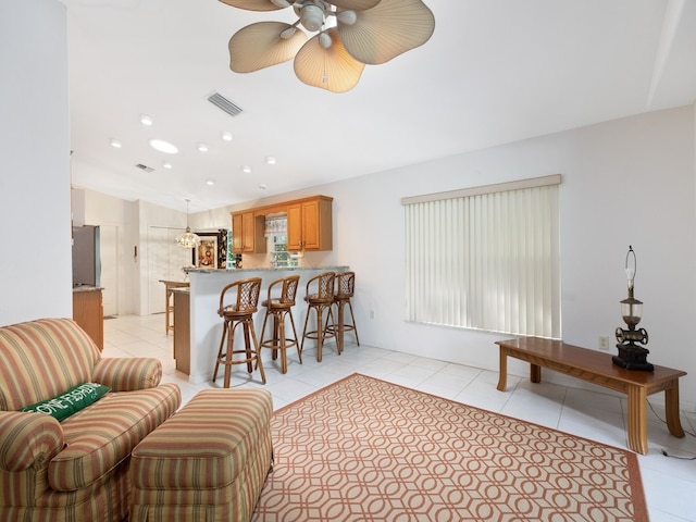 tiled living room featuring ceiling fan