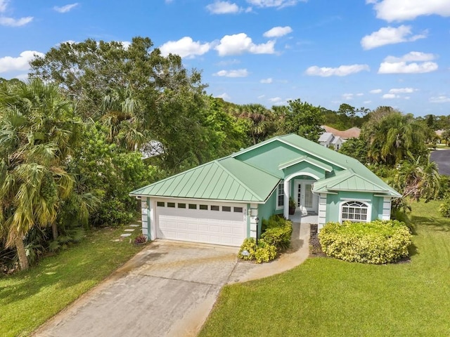 view of front of house with a garage and a front yard