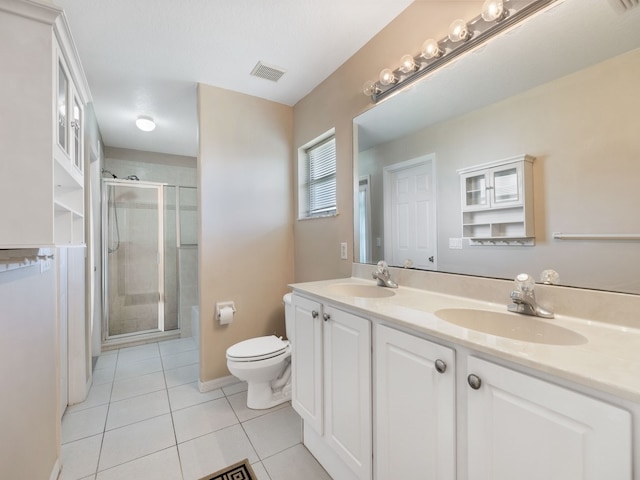 bathroom with toilet, tile patterned floors, an enclosed shower, and vanity