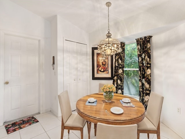 tiled dining room featuring a notable chandelier