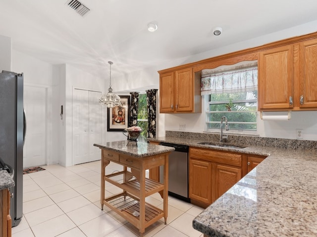 kitchen with dishwasher, sink, light tile patterned flooring, black refrigerator, and light stone counters