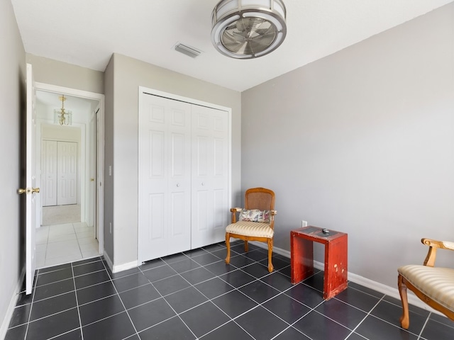 sitting room featuring dark tile patterned flooring