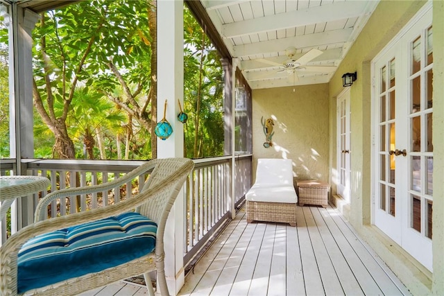 sunroom featuring french doors and a ceiling fan