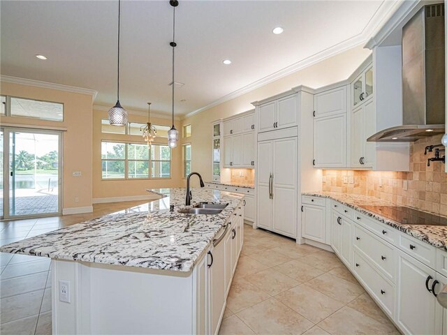4440 Jacqueline Mnr SW, Vero Beach, FL 32968 - kitchen with wall chimney exhaust hood, a sink, light tile patterned floors, glass insert cabinets, and backsplash