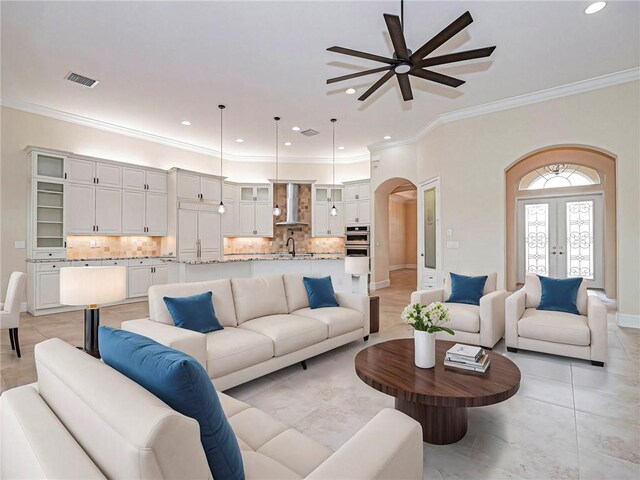 4440 Jacqueline Mnr SW, Vero Beach, FL 32968 - living area featuring a ceiling fan, arched walkways, crown molding, recessed lighting, and light tile patterned floors