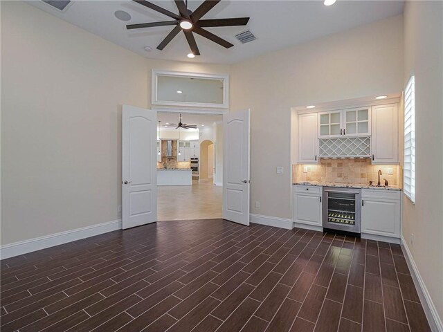 4440 Jacqueline Mnr SW, Vero Beach, FL 32968 - indoor wet bar with ceiling fan, wine cooler, backsplash, arched walkways, and baseboards