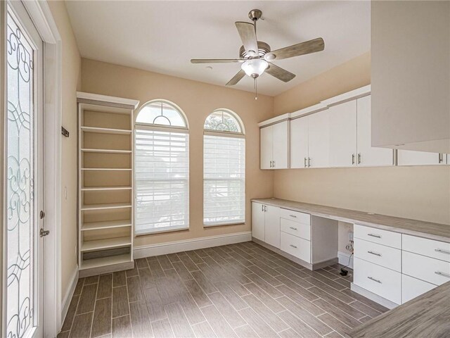 4440 Jacqueline Mnr SW, Vero Beach, FL 32968 - unfurnished office featuring built in study area, a ceiling fan, baseboards, and wood finished floors